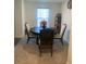 Round dining table with four chairs in well-lit dining room at 15155 Sw 52 Cir, Ocala, FL 34473