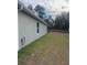 Side view of house with gray siding and a grassy yard at 15155 Sw 52 Cir, Ocala, FL 34473