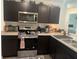 Modern kitchen featuring stainless steel appliances and dark cabinetry at 15155 Sw 52 Cir, Ocala, FL 34473