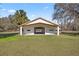 White barn with multiple stalls and covered walkway at 15315 Nw 115Th Ct, Reddick, FL 32686