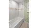 Clean bathroom with shower/tub combo and tile surround at 15315 Nw 115Th Ct, Reddick, FL 32686