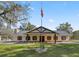 Ranch-style home with covered porch and landscaped yard at 15315 Nw 115Th Ct, Reddick, FL 32686