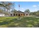 Front view of a ranch home with a large yard at 15315 Nw 115Th Ct, Reddick, FL 32686