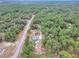 Aerial view of a home on a wooded lot with a long driveway at 18300 Sw 69 Loop, Dunnellon, FL 34432