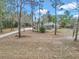 Single-story house on a large lot with a long driveway, surrounded by trees at 18300 Sw 69 Loop, Dunnellon, FL 34432