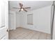 Bright bedroom with tile flooring, ceiling fan, and spacious closet at 18300 Sw 69 Loop, Dunnellon, FL 34432