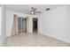 Bedroom with tile floors, sliding glass door to patio, and ceiling fan at 18300 Sw 69 Loop, Dunnellon, FL 34432