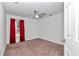 Bright bedroom with red curtains and carpeted floor at 18300 Sw 69 Loop, Dunnellon, FL 34432