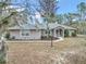 Single-story house with a gray exterior and landscaping at 18300 Sw 69 Loop, Dunnellon, FL 34432