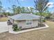 Single story house with gray exterior, landscaping, and walkway at 18300 Sw 69 Loop, Dunnellon, FL 34432