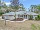 Single-story house with gray exterior and landscaping at 18300 Sw 69 Loop, Dunnellon, FL 34432