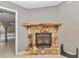 Stone fireplace with a wood mantel and decorative screen at 18300 Sw 69 Loop, Dunnellon, FL 34432