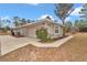 Attached garage with landscaping and a concrete driveway at 18300 Sw 69 Loop, Dunnellon, FL 34432