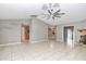 Open living room with tile floors, neutral walls, and a ceiling fan at 18300 Sw 69 Loop, Dunnellon, FL 34432