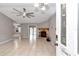 Living room with tile floors, a stone fireplace, and a ceiling fan at 18300 Sw 69 Loop, Dunnellon, FL 34432