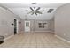 Living room with tile floors, high ceilings and ceiling fan at 18300 Sw 69 Loop, Dunnellon, FL 34432