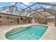 Inviting kidney-shaped pool with screened enclosure at 18300 Sw 69 Loop, Dunnellon, FL 34432