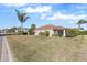 Spacious backyard with grassy lawn and screened patio at 1982 Somerset Ave, The Villages, FL 32162