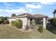 Landscaped backyard featuring lush greenery and a patio at 1982 Somerset Ave, The Villages, FL 32162