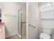 Bathroom with shower, grab bars, and toilet at 1982 Somerset Ave, The Villages, FL 32162