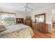 Bedroom with wood floors, large dresser, and window at 1982 Somerset Ave, The Villages, FL 32162