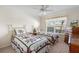 Guest bedroom with twin beds, dresser and TV at 1982 Somerset Ave, The Villages, FL 32162