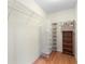 Walk-in closet with shelving and rod for hanging clothes at 1982 Somerset Ave, The Villages, FL 32162