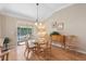 Bright dining room with glass table and sliding door access to patio at 1982 Somerset Ave, The Villages, FL 32162