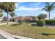 Single-story home with a two-car garage and lush landscaping at 1982 Somerset Ave, The Villages, FL 32162