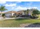 Single story home with landscaped yard and driveway at 1982 Somerset Ave, The Villages, FL 32162