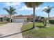 Single-story home with two-car garage and manicured lawn at 1982 Somerset Ave, The Villages, FL 32162