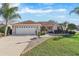 Single-story home with two-car garage and landscaping at 1982 Somerset Ave, The Villages, FL 32162