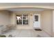 Covered front porch with seating area and a white door at 1982 Somerset Ave, The Villages, FL 32162