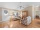 Bright and airy living room with hardwood floors and comfy seating at 1982 Somerset Ave, The Villages, FL 32162