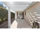 White pergola covers patio, leading to a screened porch at 1982 Somerset Ave, The Villages, FL 32162