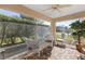 Screened porch with wicker furniture and ceiling fan at 1982 Somerset Ave, The Villages, FL 32162