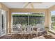 Bright and airy screened porch with wicker furniture at 1982 Somerset Ave, The Villages, FL 32162