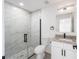 Modern bathroom with marble-look shower, granite countertop vanity, and white fixtures at 200 Oak Lane Run, Ocala, FL 34472