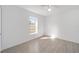 Sunny bedroom with wood-look tile floors and a large window at 200 Oak Lane Run, Ocala, FL 34472