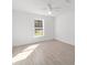 Well-lit bedroom featuring wood-like tile floors and a ceiling fan at 200 Oak Lane Run, Ocala, FL 34472