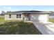 Front view of a newly built house with a white garage door at 200 Oak Lane Run, Ocala, FL 34472