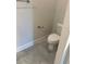 Bathroom featuring neutral paint, gray tile flooring, and a toilet at 2158 Nw 23Rd Loop, Ocala, FL 34475