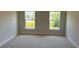 Bedroom with two windows bringing in natural light and neutral carpeting at 2158 Nw 23Rd Loop, Ocala, FL 34475