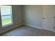 Cozy bedroom with carpet, natural light from the window, neutral paint, and a closet at 2158 Nw 23Rd Loop, Ocala, FL 34475