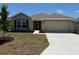 Charming one-story home with a two-car garage, manicured lawn, and a traditional architectural style at 2158 Nw 23Rd Loop, Ocala, FL 34475