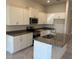 Bright kitchen with white cabinets, stainless steel appliances, granite countertops, and a kitchen island at 2158 Nw 23Rd Loop, Ocala, FL 34475