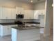 A well-lit kitchen with granite countertops, a center island, and stainless steel appliances at 2158 Nw 23Rd Loop, Ocala, FL 34475