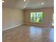 Inviting living room with tile flooring, natural light, neutral paint, and a sliding glass door at 2158 Nw 23Rd Loop, Ocala, FL 34475