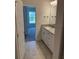 Bathroom featuring granite vanity with a sink, white cabinets, and a view into the bedroom at 2162 Nw 23Rd Loop, Ocala, FL 34475