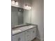 Bathroom featuring double sinks, granite countertops, ample cabinetry, and decorative lighting fixtures at 2162 Nw 23Rd Loop, Ocala, FL 34475